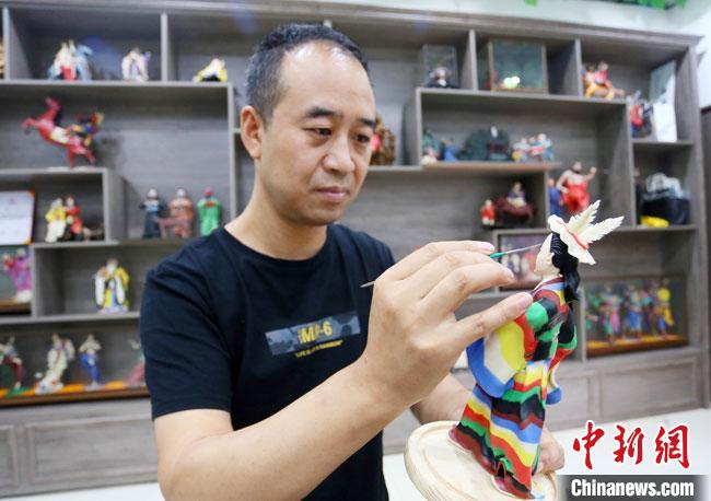 圖為安秋平正在創作代表隴南文縣民俗的《白馬人》作品?！「哒?攝