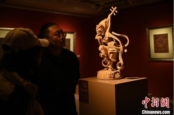 圖為季茂杰向參觀者介紹自己創作敦煌木雕的過程。李亞龍 攝</p>
<p>