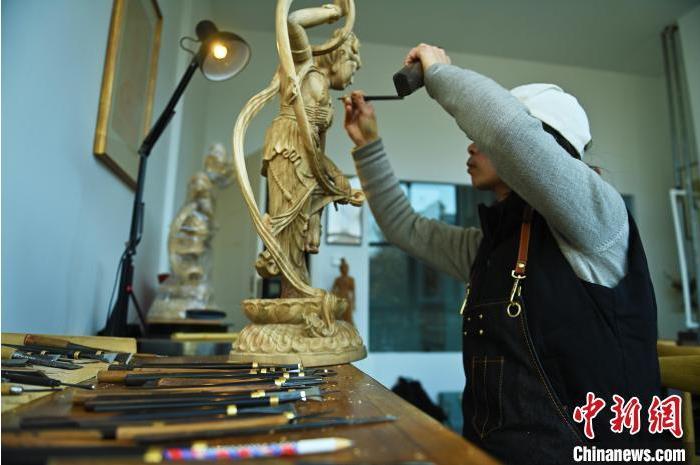 圖為季茂杰進行敦煌元素的木雕創作。李亞龍 攝</p>
<p>